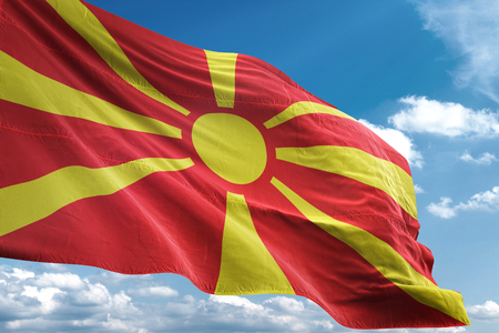 Macedonia flag waving blue sky background 3D illustrationの写真素材
