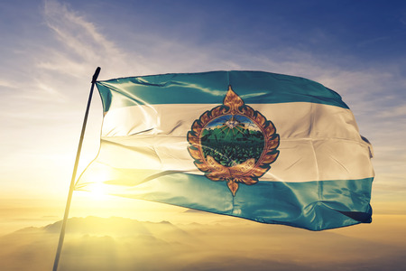 Phetchabun province of Thailand flag textile cloth fabric waving on the top sunrise mist fogの写真素材