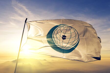 Organisation of Islamic Cooperation OIC flag textile cloth fabric waving on the top sunrise mist fogのeditorial素材