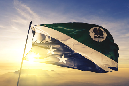 Western Highlands province of Papua New Guinea flag textile cloth fabric waving on the top sunrise mist fogの写真素材