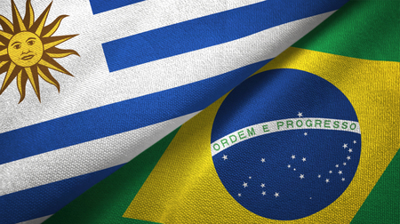 Uruguay and Brazil flags together textile cloth, fabric textureの写真素材