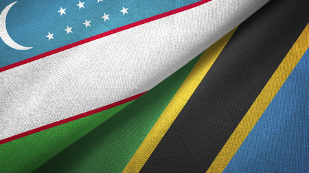 Uzbekistan and Tanzania two folded flags togetherの写真素材