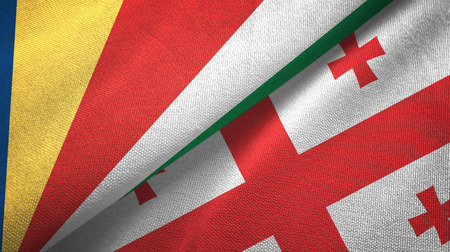 Seychelles and Georgia two flags textile cloth, fabric textureの写真素材