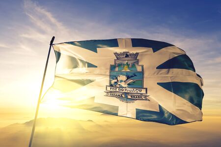 Foz do Iguacu of Brazil flag textile cloth fabric waving on the top sunrise mist fogの写真素材