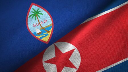 Guam and North Korea two folded flags togetherの写真素材
