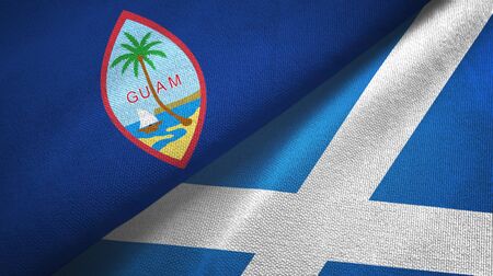 Guam and Scotland two folded flags togetherの写真素材