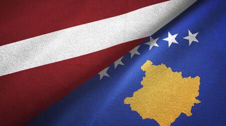 Latvia and Kosovo two folded flags togetherの写真素材