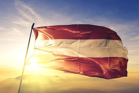 Bouillon of Luxembourg of Belgium flag textile cloth fabric waving on the top sunrise mist fogの写真素材