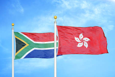South Africa and Hong Kong two flags on flagpoles and blue cloudy sky backgroundの写真素材