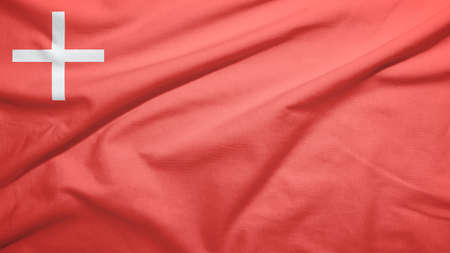 Schwyz canton of Switzerland flag on the fabric texture backgroundの写真素材