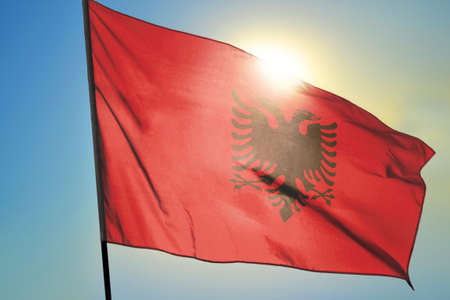 Albania flag waving on the wind in front of sunの写真素材
