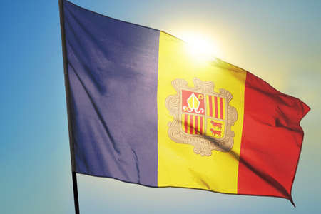 Andorra flag waving on the wind in front of sunの写真素材