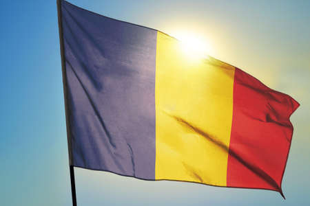 Chad flag waving on the wind in front of sunの写真素材