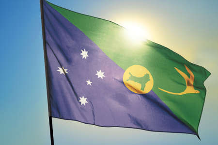 Christmas Island flag waving on the wind in front of sunの写真素材