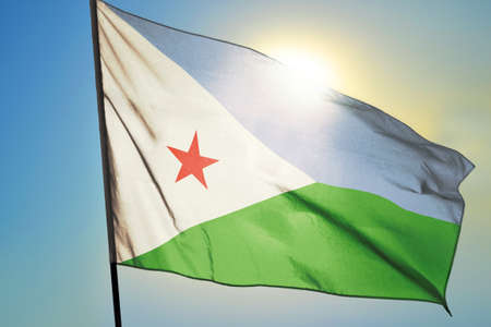 Djibouti flag waving on the wind in front of sunの写真素材
