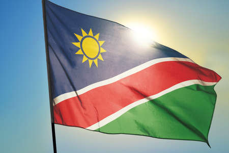 Namibia flag waving on the wind in front of sunの写真素材