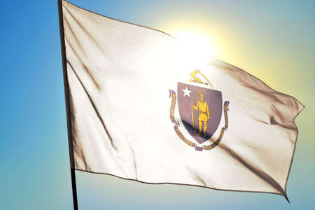 Massachusetts state of United States flag waving on the wind in front of sun