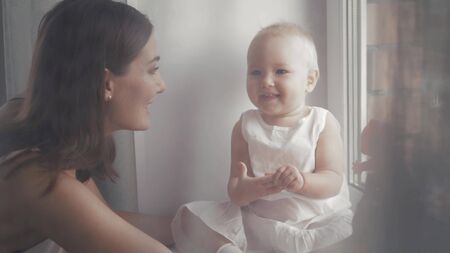 Happy family laughing faces, mother holding adorable child baby boy, smiling and hugging, close border, beauty of smile, female isolated on white, healthy kid joyful mom, expressing love emotionsの写真素材