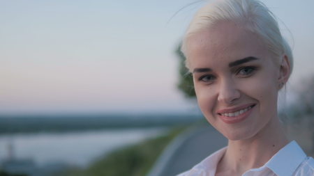 Portrait of Young Beautiful Blonde Woman In The City Smiling In Sunset, 4K, UHD