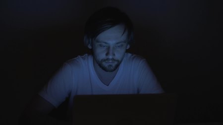 businessman working with computer at night in officeの写真素材