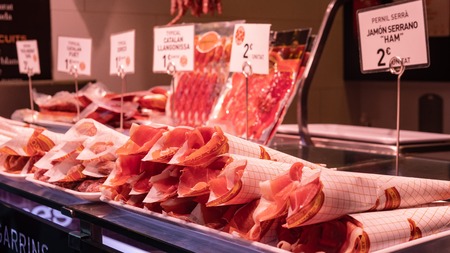 Boqueria market, jamon and sausages on the counter of the Spanish marketの写真素材