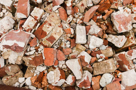 Close-up of a pile of old broken red bricks
