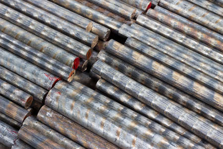 background of a pile of bronze rods closeupの写真素材