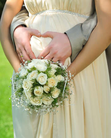 the pregnant woman embraces for a tummy of a hand of the husbandの写真素材