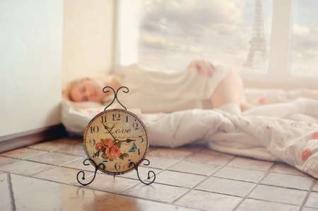 against a sleeping two-room flat hours stand on the floorの写真素材