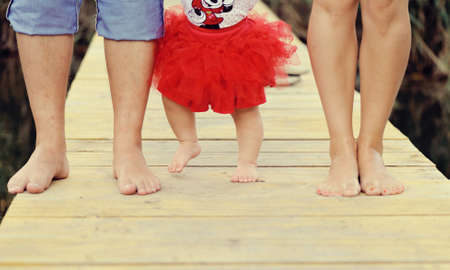 on the derevanny bridge of a foot of a familyの写真素材