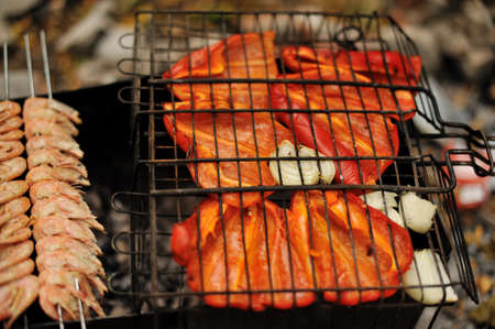 On a brazier the appetizing shish kebab from shrimps with red pepper is friedの写真素材