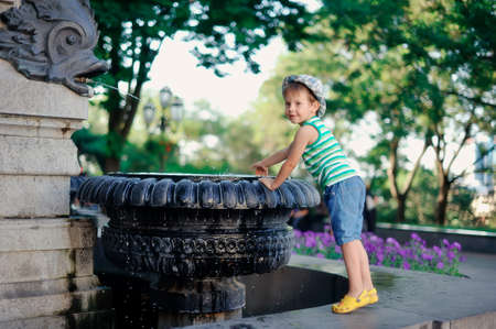 the boy at a fountainの写真素材