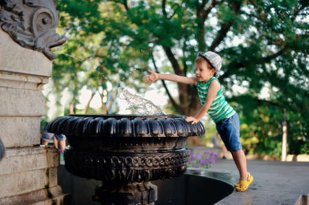 the boy at a fountainの写真素材