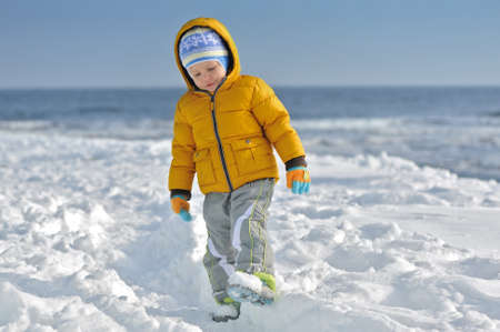 the child walks winter in the snow afternoonの写真素材