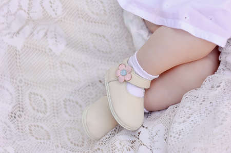 on a white background small children s feet in beautiful shoes lieの写真素材