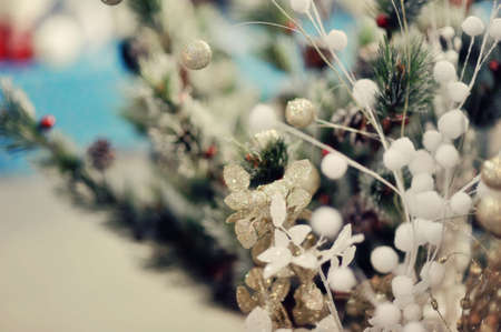 the child decorates a green New Year tree with color toysの写真素材