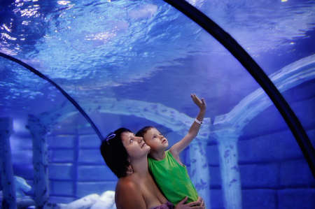 on a blue background mother and son on trips to the aquariumの写真素材