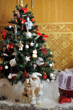 under the Christmas tree is decorated with toys, santa claus in a white suitの写真素材