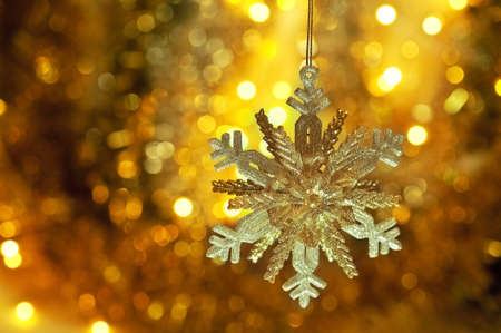 on a gold background shiny big beautiful snowflakeの写真素材