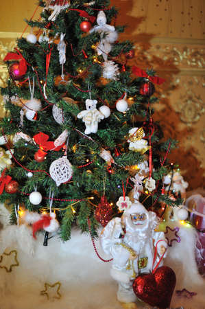 under the Christmas tree is decorated with toys, santa claus in a white suitの写真素材