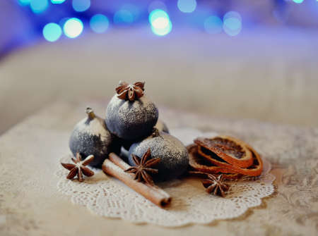 Christmas still life fragrant, beautiful spices on a background of lightsの写真素材
