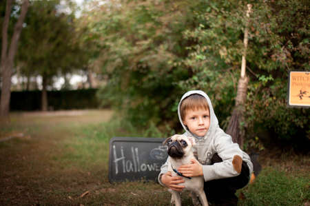 the nature boy hugs his beloved dog breed pugの写真素材