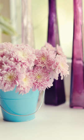 beautiful delicate bouquet of pink chrysanthemums in a blue bucketの写真素材