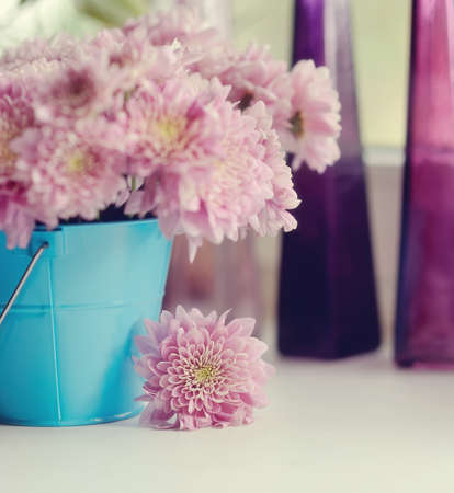 beautiful delicate bouquet of pink chrysanthemums in a blue bucketの写真素材