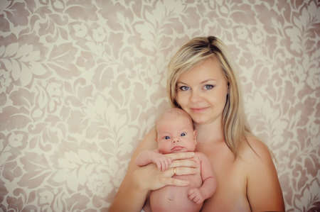 delicate and feminine mother tenderly embracing her childの写真素材