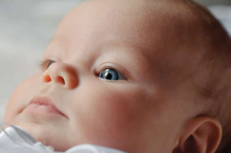 closeup charming face thoughtful boy staring into the distanceの写真素材
