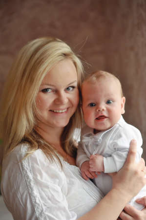 delicate and feminine mother tenderly embracing her childの写真素材
