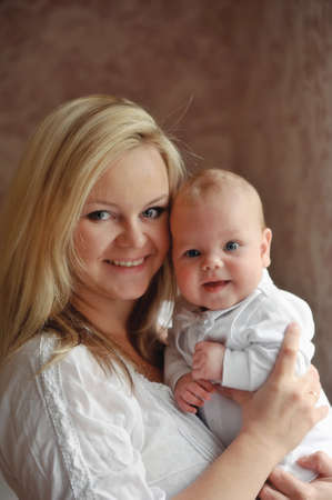 delicate and feminine mother tenderly embracing her childの写真素材