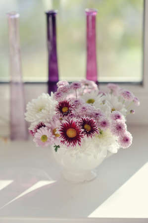 beautiful delicate bouquet of pink chrysanthemums in a blue bucketの写真素材