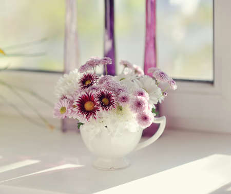 beautiful delicate bouquet of pink chrysanthemums in a blue bucketの写真素材